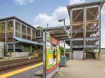 A train station with two platforms and a platform with a sign on it